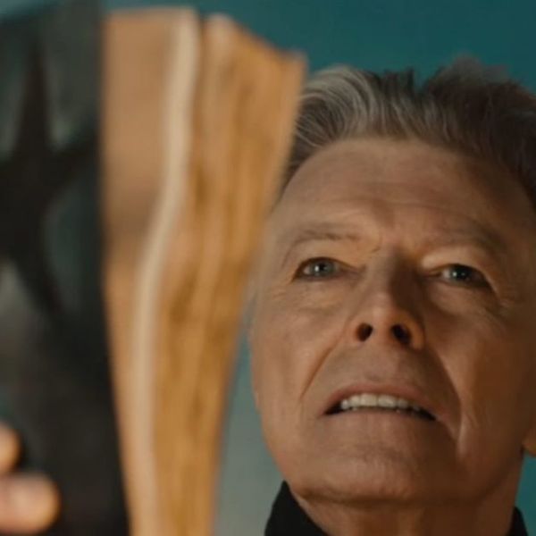 David Bowie holding a bible